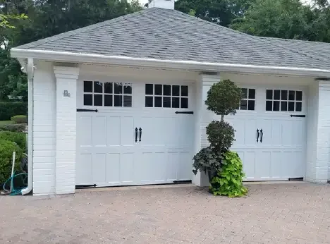 White garage building with two carriage style doors